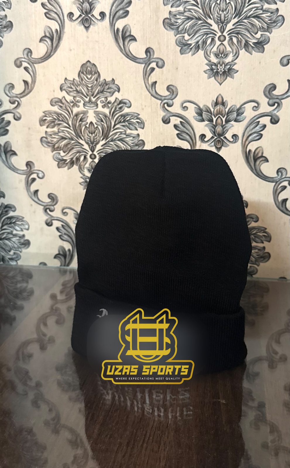 Black cuffed beanie with an embroidered logo (customer logo replaced)