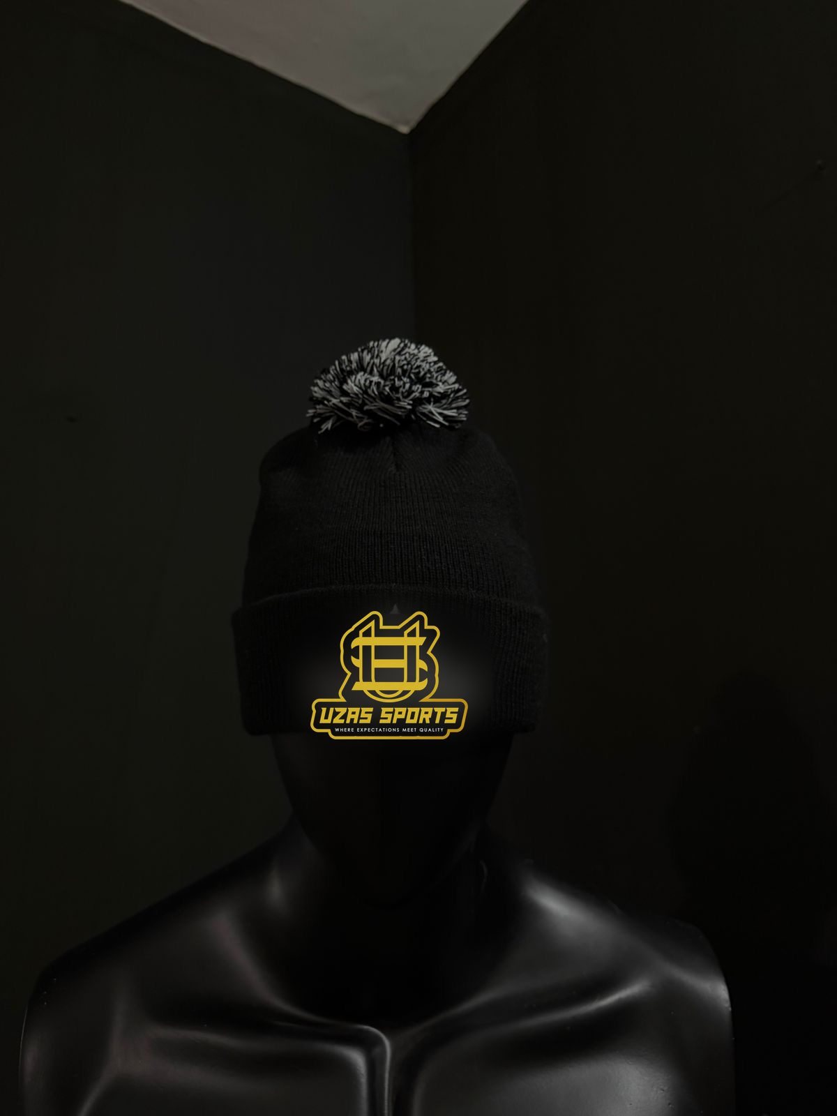 Black pom beanie with an embroidered logo (customer logo replaced)