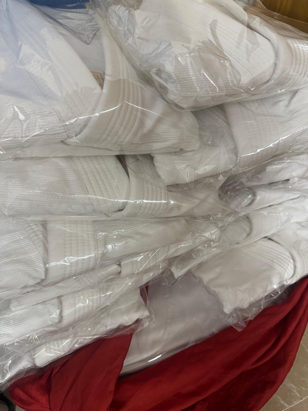 Martial arts uniforms packed in poly bags for a bulk order