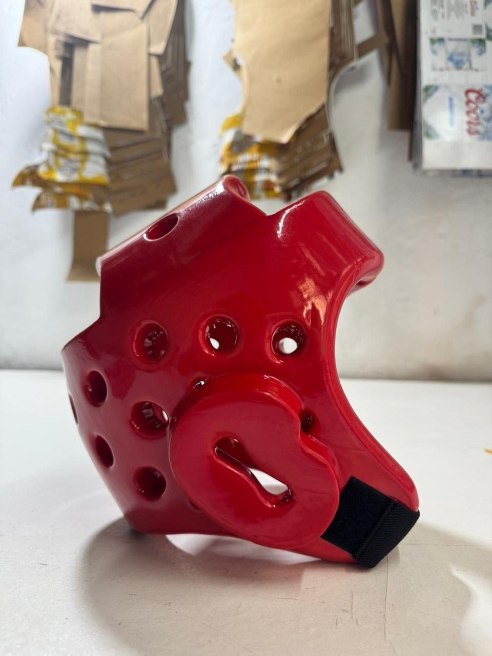 Red taekwondo head guard from the side