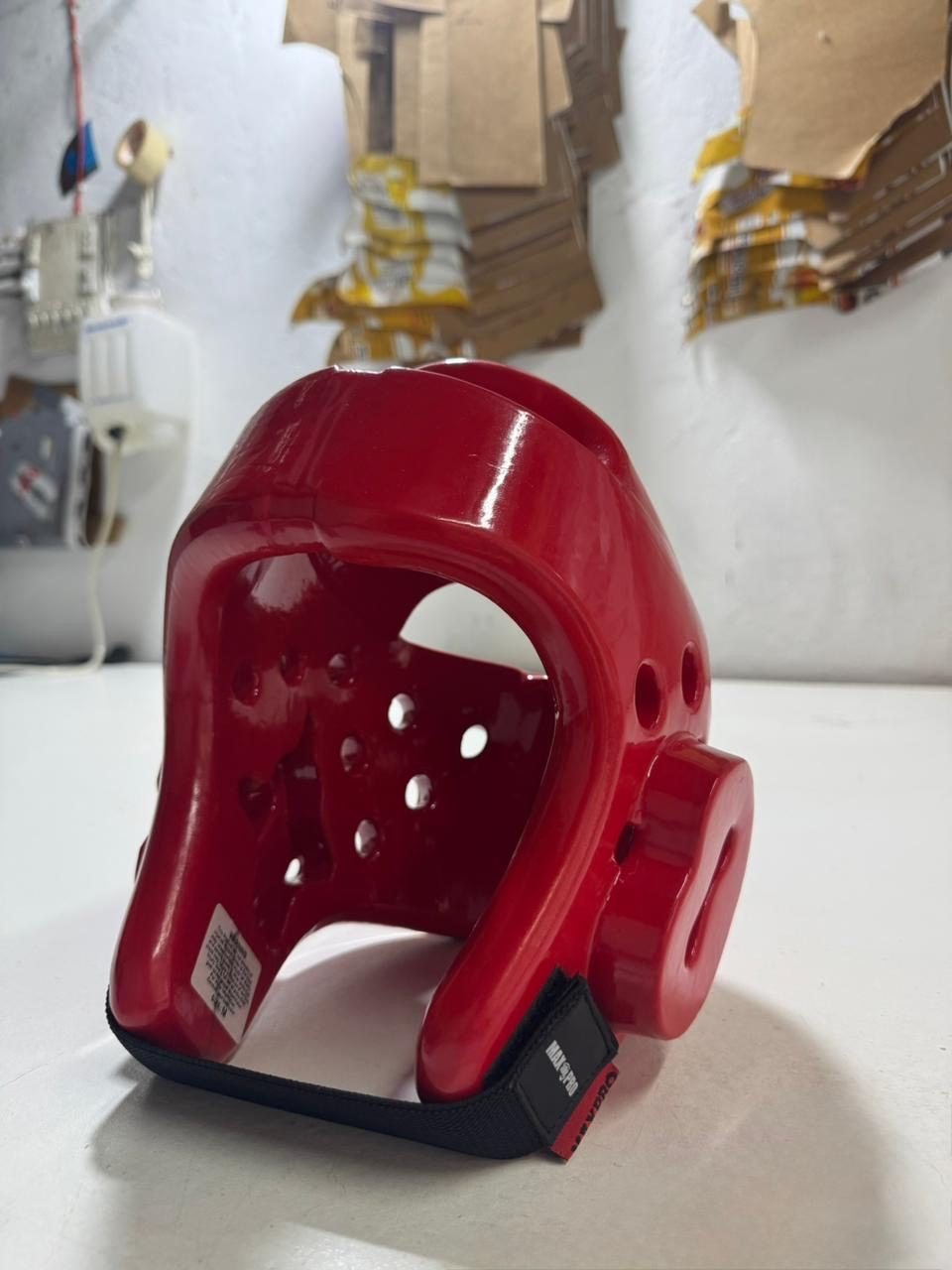 Red taekwondo head guard made at the UZAS Sports factory