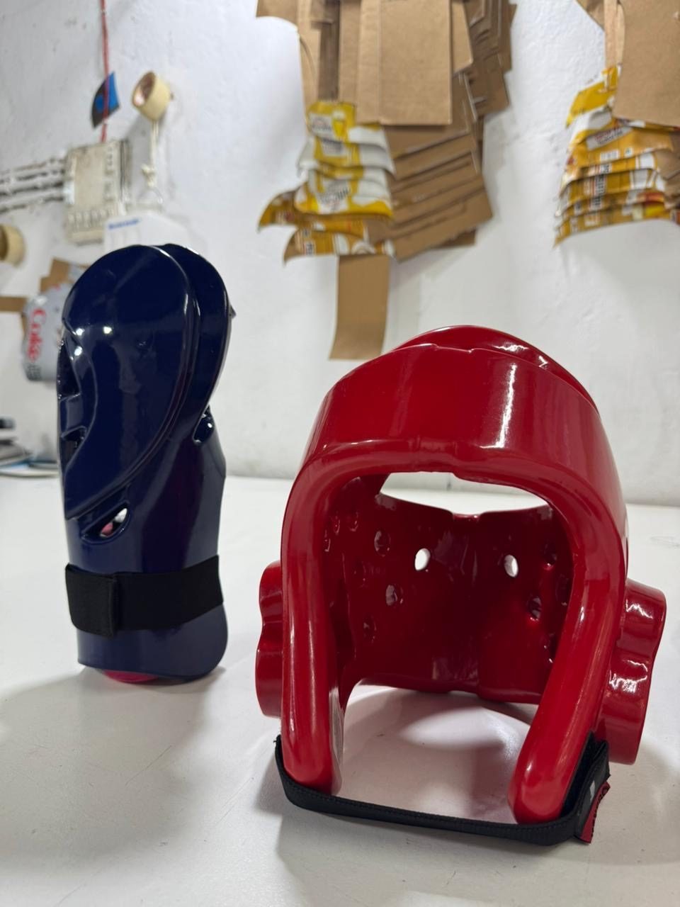 Blue taekwondo forearm guard and red head guard